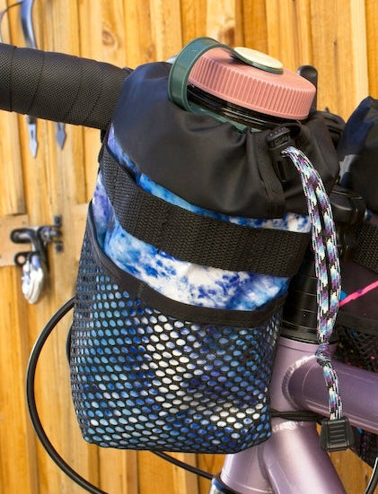 Blue tie-dye stem bag mounted to the handlebars.